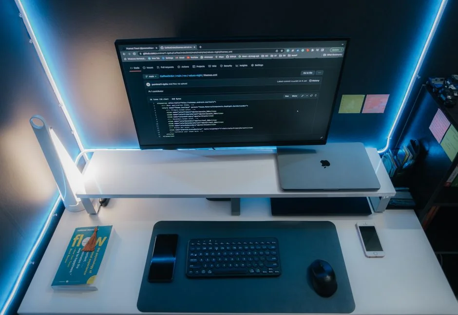 A modern computer screen displaying web design work, showcasing creative visuals in a workspace.