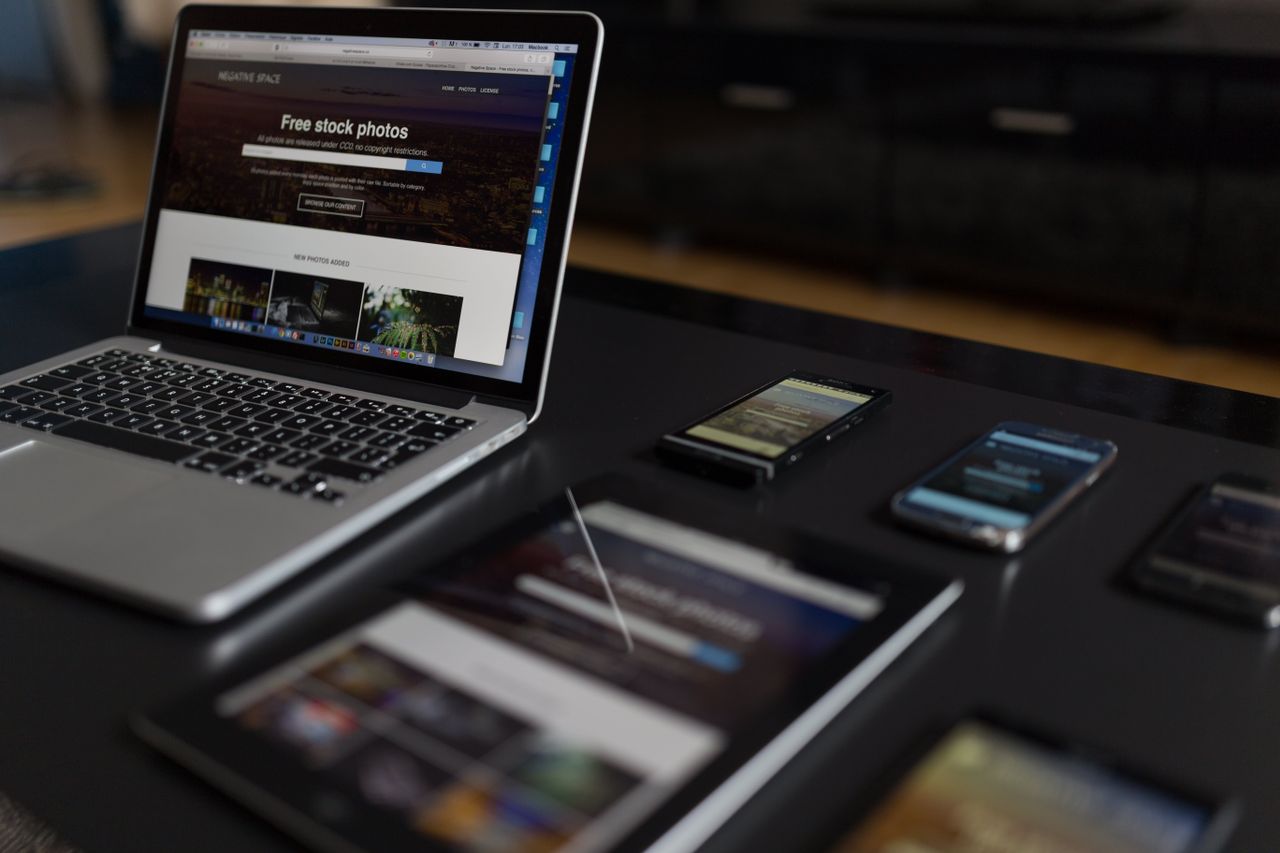 A modern workspace featuring a laptop, tablet, and smartphones, perfectly suited to tech work and freelance projects.